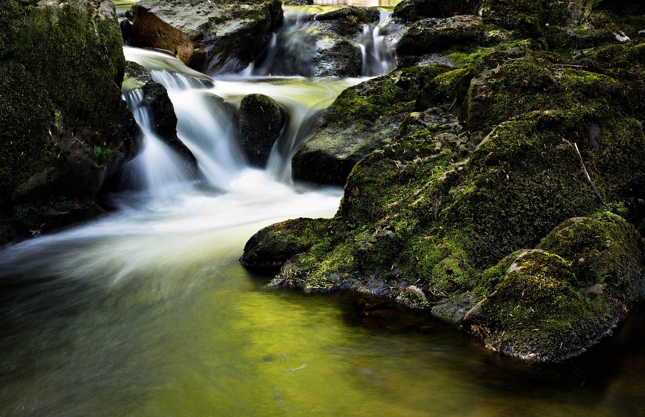 Gentle creek water flowing over rocks